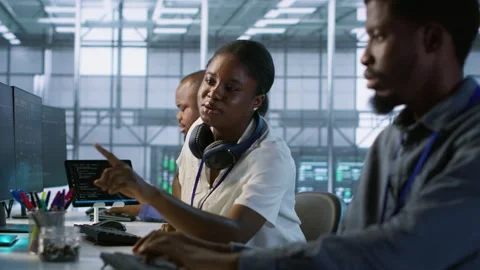 Engineer arrives in data center, puts headphones on, implementing AI systems Stock Footage 319560244