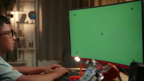 Engineer Asian Boy Is Working With Desktop Computer In Home, Mock Up Green Stock Footage 158692851