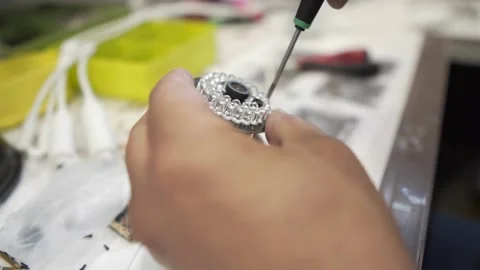 Engineer Assembles a CCTV camera by screwing the parts with a plug. Workshop Stock Footage 142341210