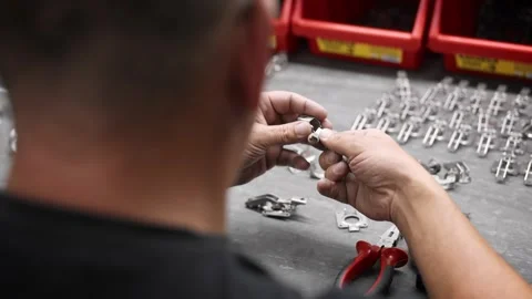 An engineer assembles metal parts Stock Footage 259613384