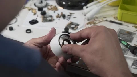 Engineer Assembles Outdoor CCTV Camera Housing. Workshop, Production, Assembly Stock Footage 142725947