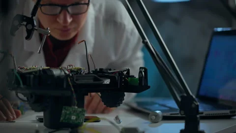 Engineer assembling electronic components on a robotics project in a modern 스톡 동영상 291436260