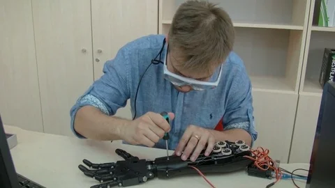 Engineer assembling innovative cybernetic bionic arm. Hi-tech innovative Stock Footage 81037119