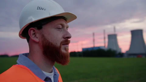 An engineer on the background of a power plant. The model looks away Stock Footage 234262146