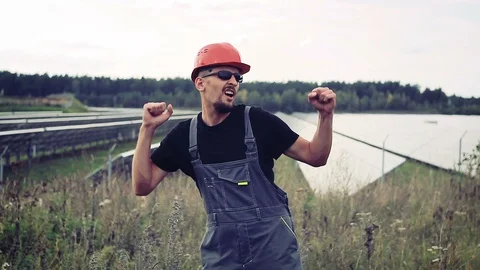 Engineer on a background of solar cells dancing Stock Footage 94554959