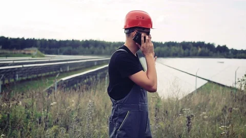 Engineer on the background of solar panels Stock Footage 96009044