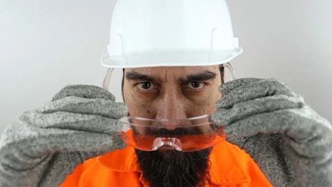 Engineer with beard wearing work helmet and safety glasses. Slow motion Video stock 151986826
