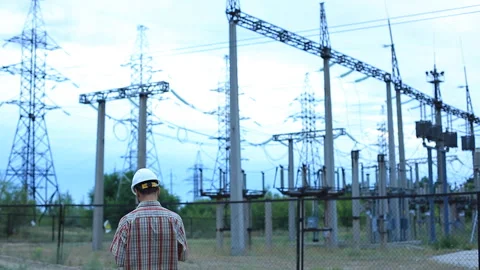 Engineer with a beard in a white helmet checkered shirt notes in a log near the Stock Footage 92779374