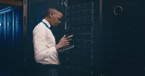 Engineer, black man and reading tablet in server room for cybersecurity Stock Photos