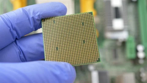 Engineer with blue gloves holds CPU chip processor Stock Footage 102474056