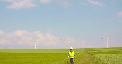 Engineer with blueprint analyzing farm against sky Stock Footage 102955082