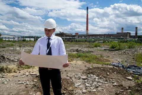 Engineer with blueprints on site Stock Photos