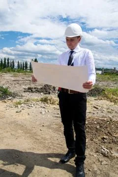 Engineer with blueprints on site Stock Photos
