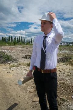 Engineer with blueprints on site Stock Photos