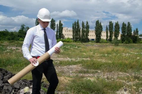 Engineer with blueprints on site Stock Photos