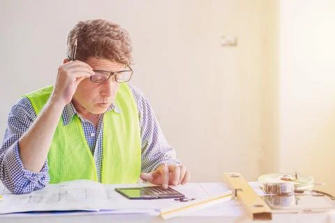 Engineer builder calculate construction bill cost feel worry for excessive .. Stock Photos