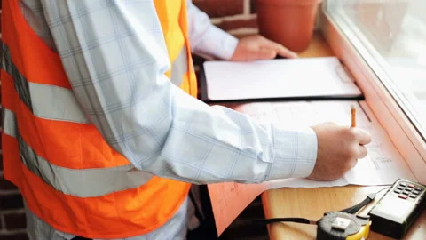 Engineer builder checks construction drawings Stock Footage 85925458