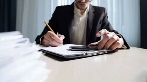 The engineer builder does the calculation and checks the drawings in the office Stock Footage 85602040