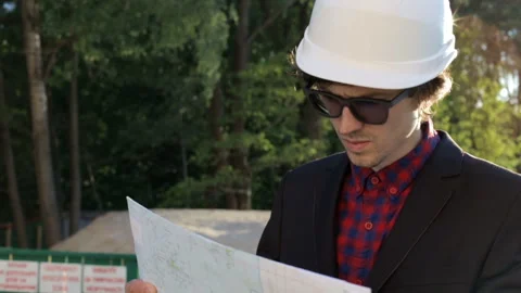 Engineer builder with drawings at the construction site Stock Footage 85748104