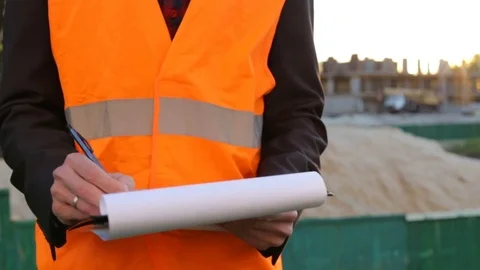 Engineer builder makes notes on construction site Video stock 76151317