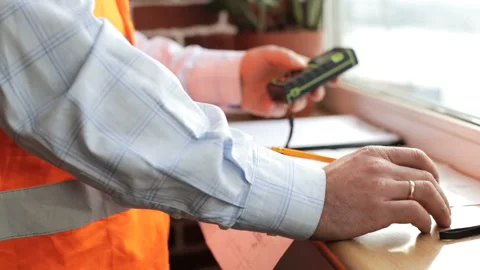Engineer builder for measurements uses laser roulette Stock Footage 87379781