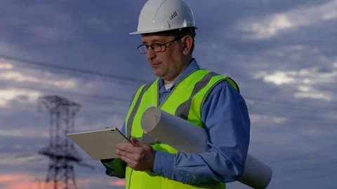 Engineer builder, power engineer works on power lines using computer tablet 스톡 동영상 252156869