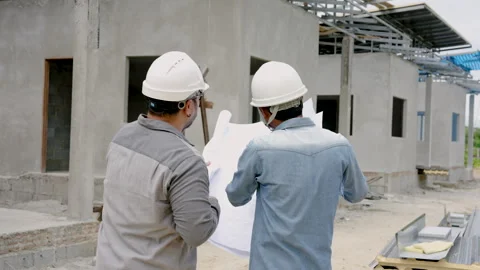 Engineer builder, standing together discussing plans, concerning construction Stock Footage 250112073