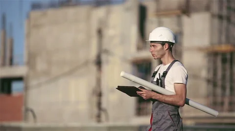 Engineer builder using tablet and walkie talkie, giving instructions Stock Footage 53604981