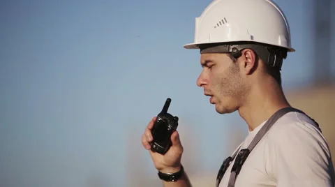 Engineer builder using tablet and walkie talkie, giving instructions Stock Footage 53604989
