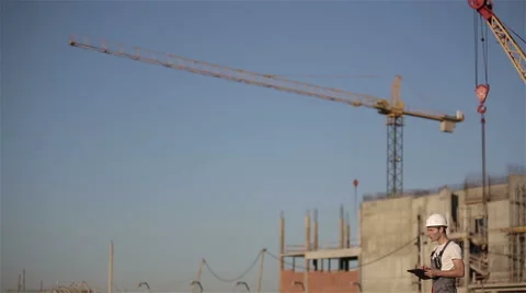 Engineer builder using tablet at a construction site. Long shot Stock Footage 53576655