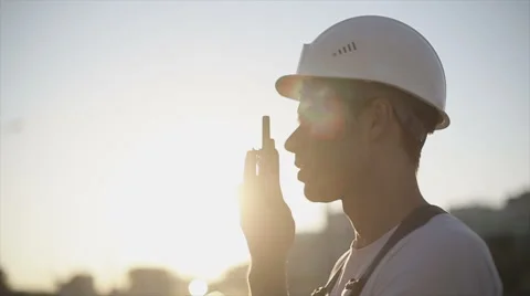 Engineer builder using a walkie talkie giving instructions Stock Footage 53576630