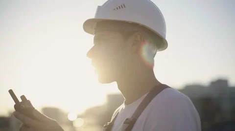 Engineer builder using a walkie talkie giving instructions Stock Footage 53606801