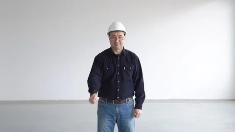 Engineer, builder in a white helmet, blue shirt and glasses shows thumb up Stock Footage 126232846