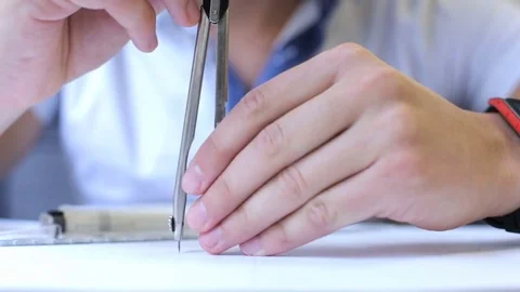 Engineer builder works with drawings using a drawing compass Stock Footage 82338595