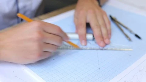 The engineer builder works on a graph paper with a ruler and a compass Stock Footage 80248771