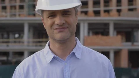 Engineer on building site showing key from new home. Closeup of young Stock Footage 111773050