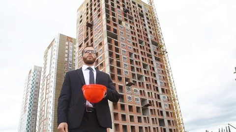 Engineer in a business suit on a construction site Stock Footage 77235101