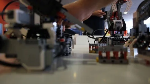 Engineer calibrate Lego robot for work on table on fair Stock Footage 113084477