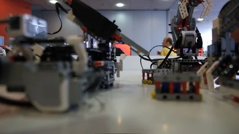 Engineer calibrate Lego robot for work on table on fair Stock Footage 113084509