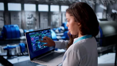 Engineer Carefully Inspects Power Plant Engine Using Laptop Stock Footage 335882307