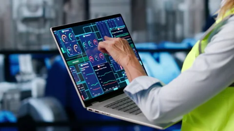 Engineer Carefully Inspects Power Plant Engine Using Laptop Stock Footage 336794415