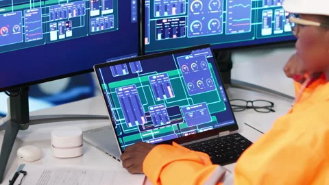 Engineer Carefully Monitors Hydropower System Data Using Laptop Stock Footage 339186076