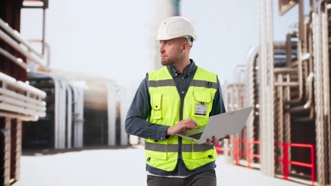 Engineer Carefully Monitors Refinery Control Systems Stock Footage 330582223