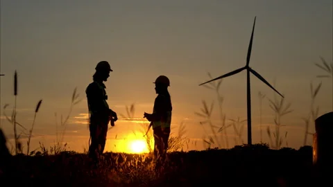 Engineer in charge of wind energy against a background of wind turbines. Stock Footage 259385008