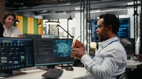 Engineer chatting with manager in office, laughing while using AI Stock Footage 323332659