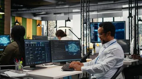 Engineer chatting with manager in office, laughing while using AI 스톡 사진
