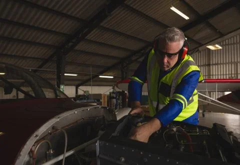 Engineer checking aircraft engine Stock Photos