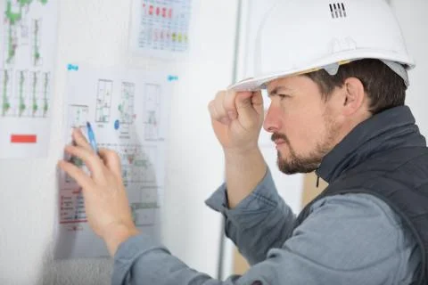 An engineer checking the blueprint Stock Photos
