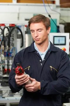 Engineer Checking Component In Factory Stock Photos