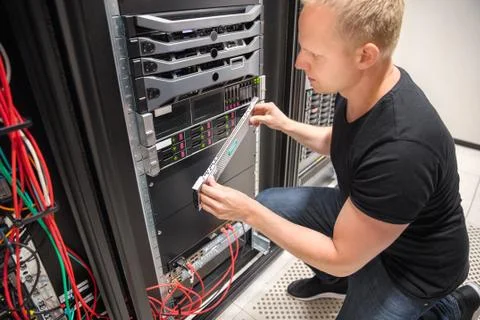 Engineer Checking Computer Server In Datacenter Stock Photos